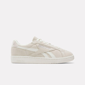 Low-top, off-white sneakers with white laces and stripes.