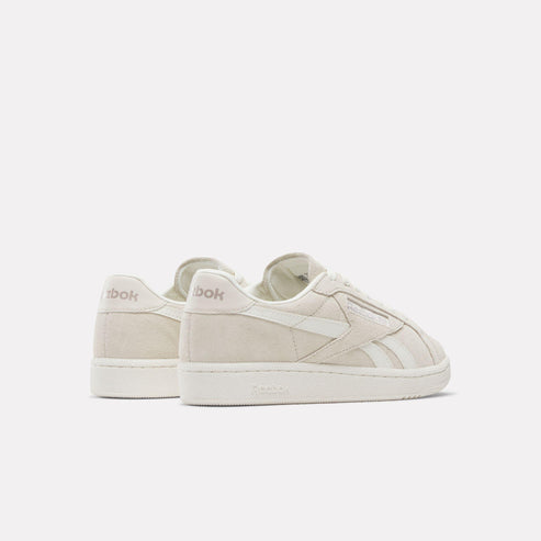 Low-rise, off-white sneakers with logo on heel.