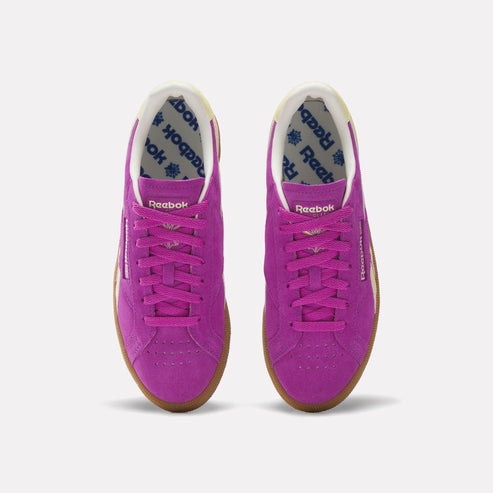 Pair of low-top shoes, purple suede, gum soles, white interior with blue print.