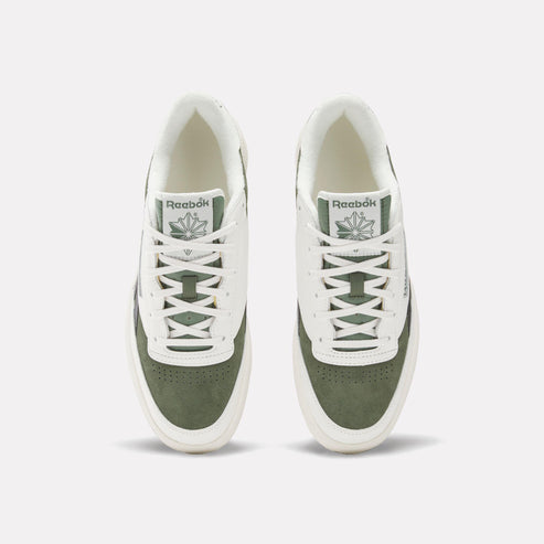 Overhead view of off-white and olive green sneakers with laces.