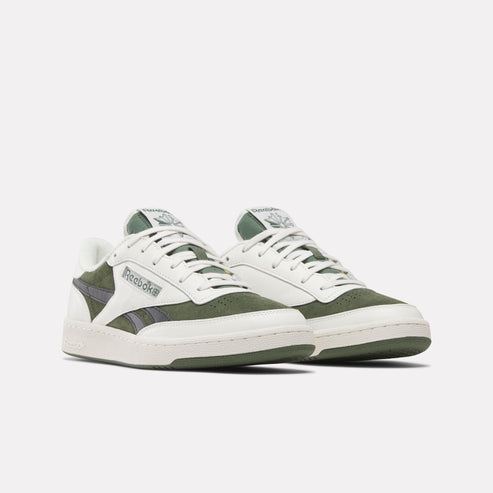 Pair of low-top white and green sneakers with white laces and white outsoles, with a gray Reebok logo on the side.