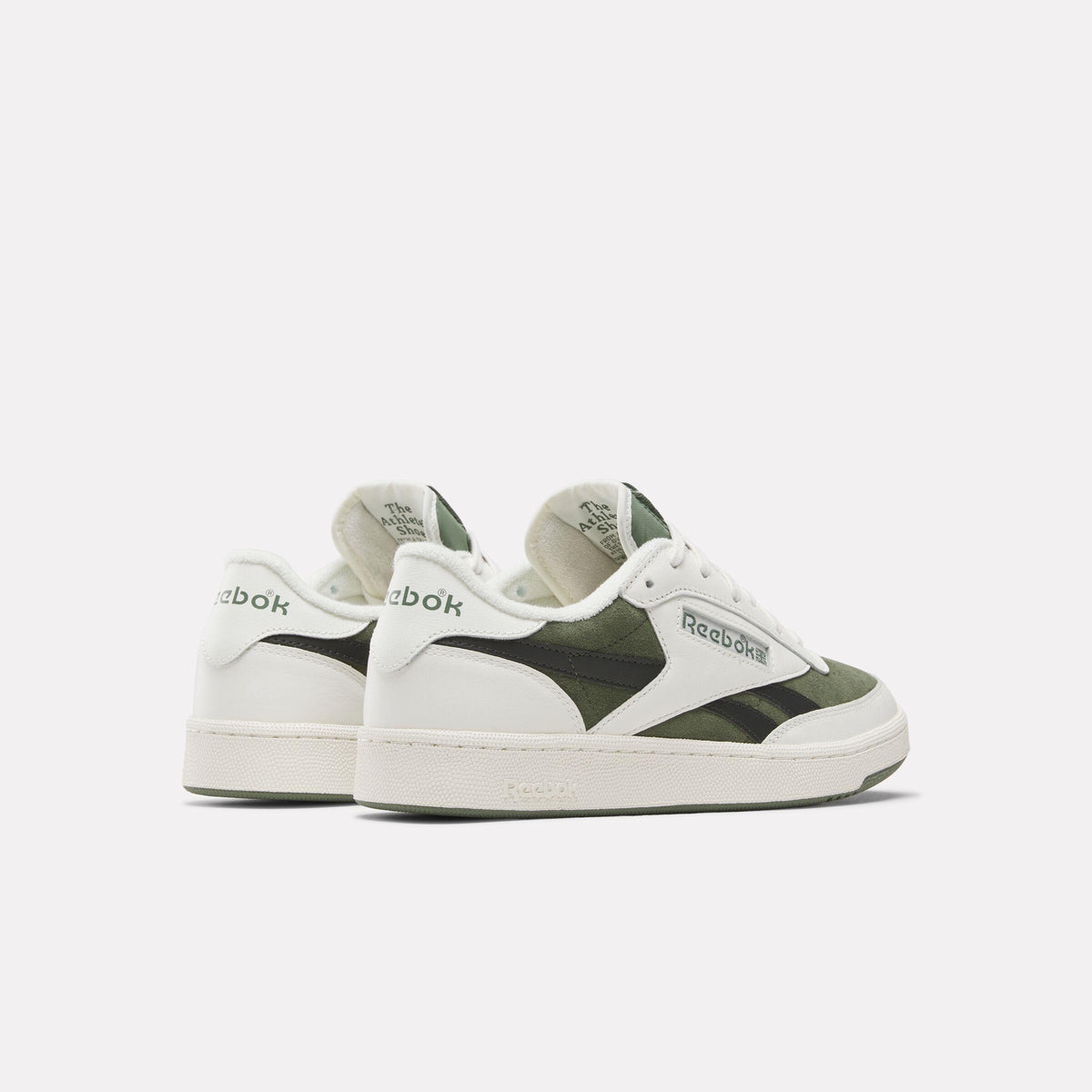 White and green low-top sneakers with the brand's name on the side.