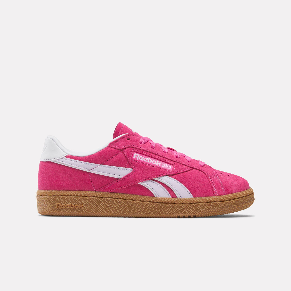 Pink suede low-top sneaker with white stripes and a brown sole.