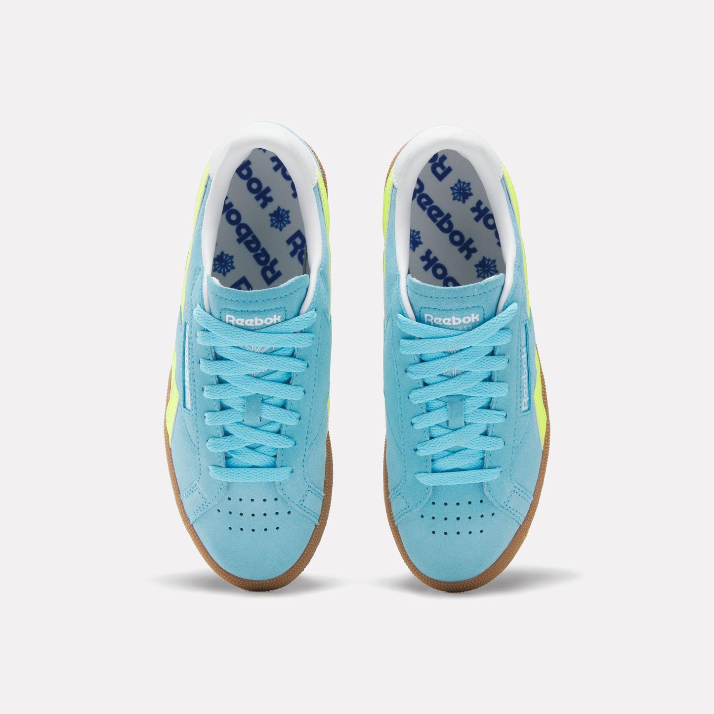 Top view of light blue shoes with light blue laces and rubber soles.