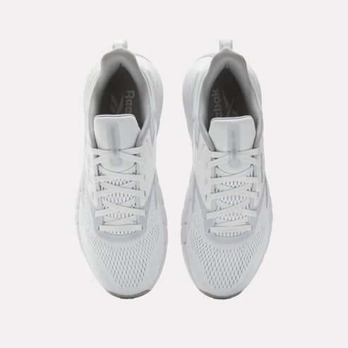 Top view of a pair of white sneakers with white laces.