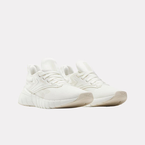 Pair of white athletic shoes with lace-up closures.