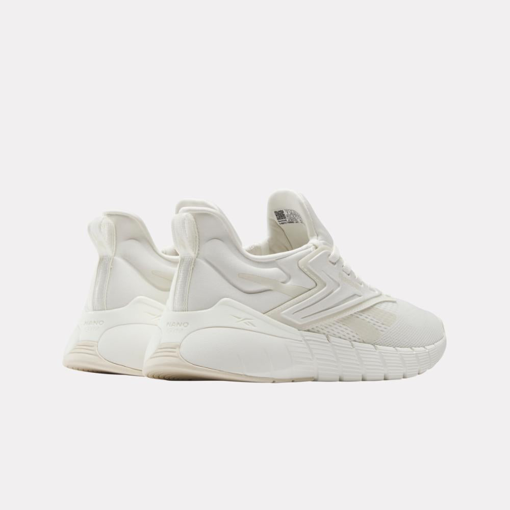 Two white low-top running sneakers with mesh detail.