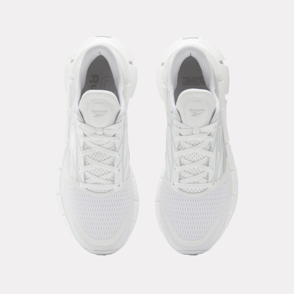Top-down view of white running shoes with laces.