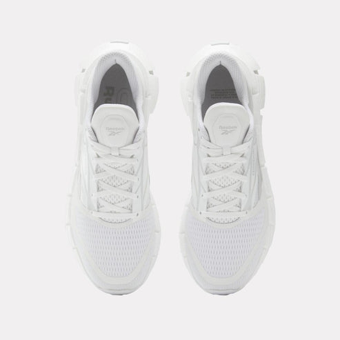 Top-down view of white running shoes with laces.