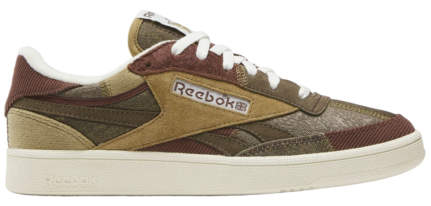 A low-top sneaker with green, brown, and tan patchwork uppers with white laces and off-white sole.