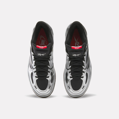 Pair of silver and black high-top athletic shoes with black laces, black and red interior.