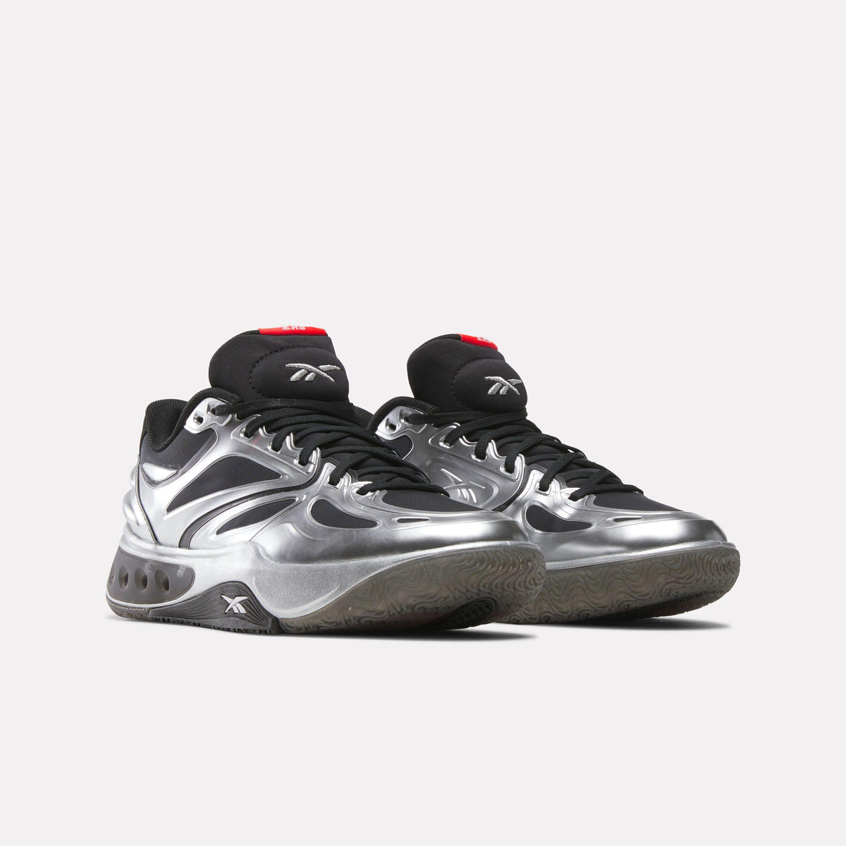 Two silver and black sneakers with black laces.