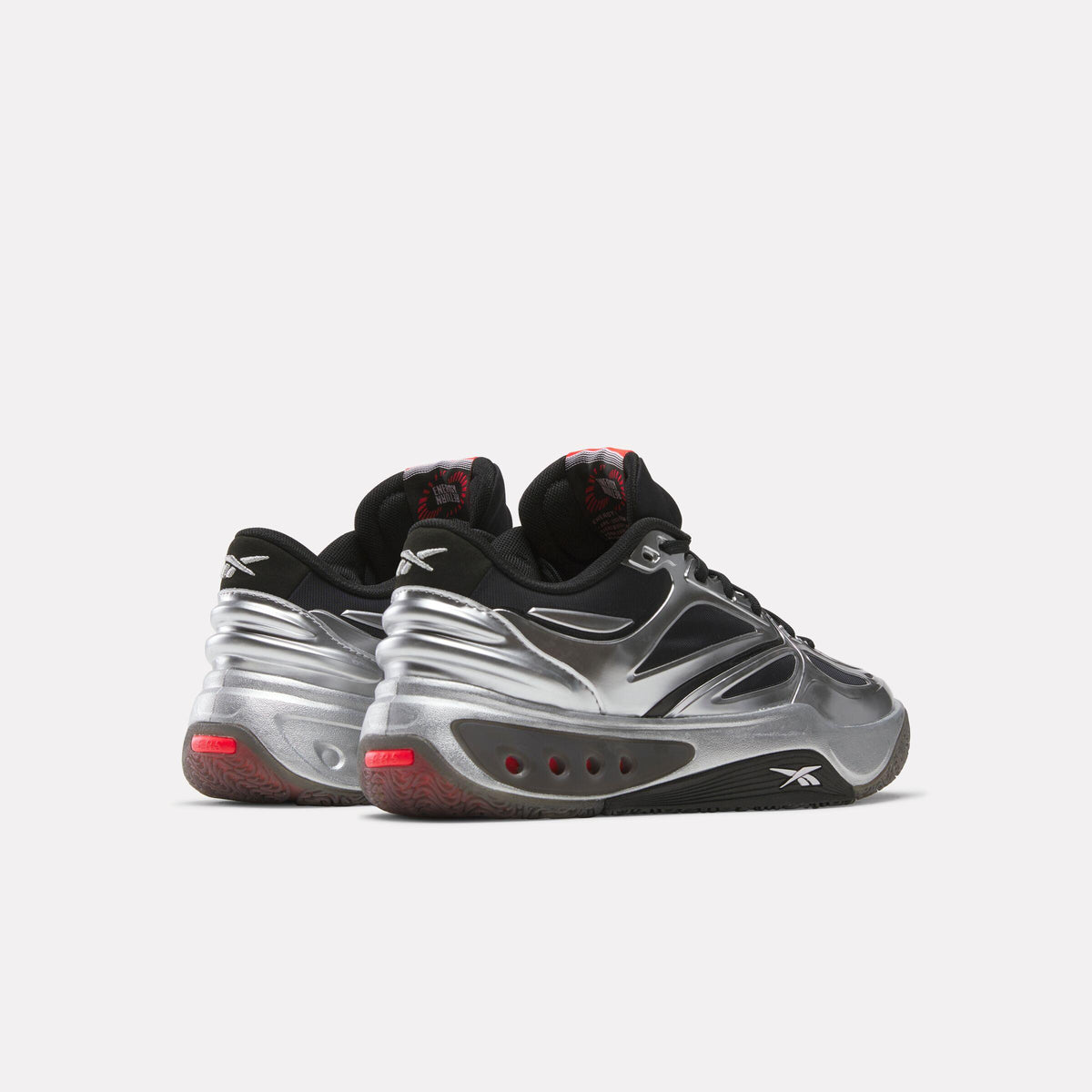 Back view of black and silver athletic shoes with red accents.