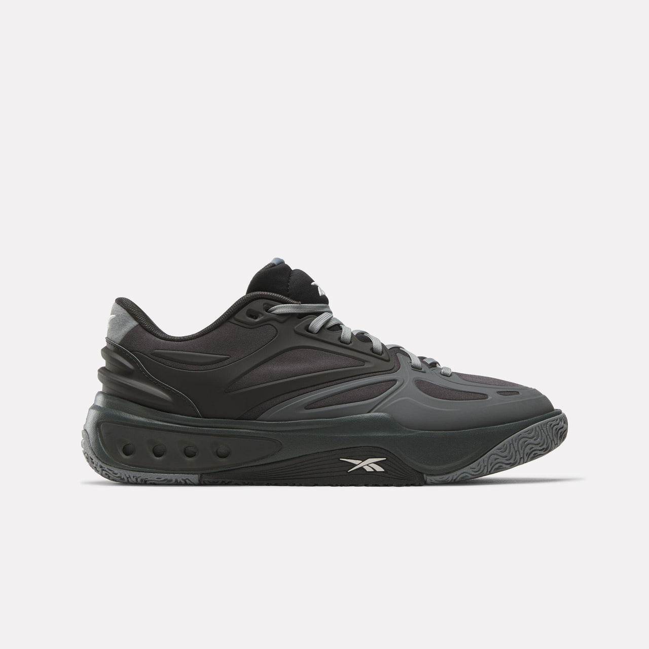 A black athletic shoe with gray laces and a gray sole featuring a small white logo near the toe.