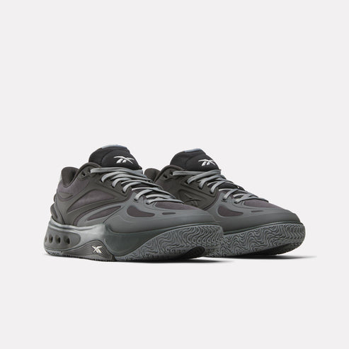 Pair of gray low-top athletic shoes with a wavy sole and logo on the side.