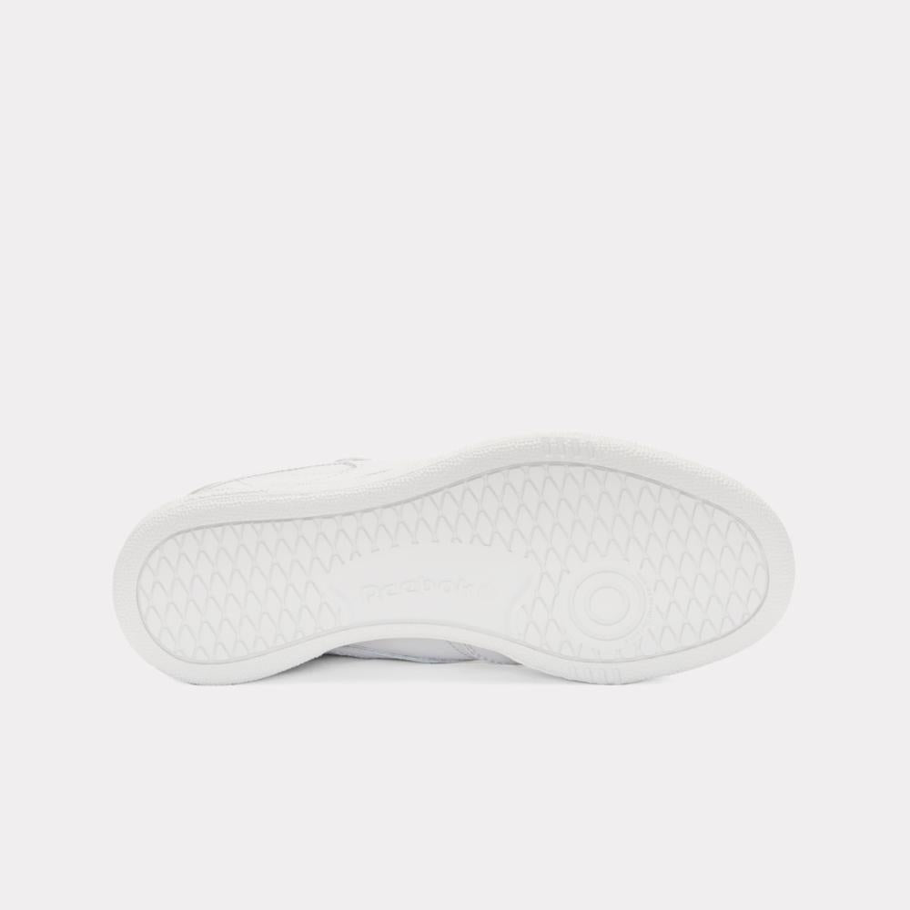 White sneaker sole with indented wavy pattern.