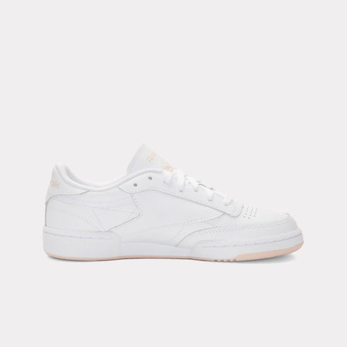 White sneaker with a perforated toe box and lace-up closure.