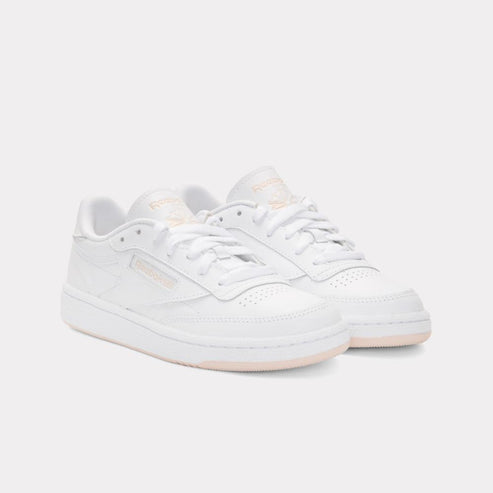 Pair of white low-top tennis shoes with white laces.