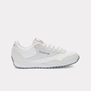 A white running shoe with grey sole and red and blue logo.