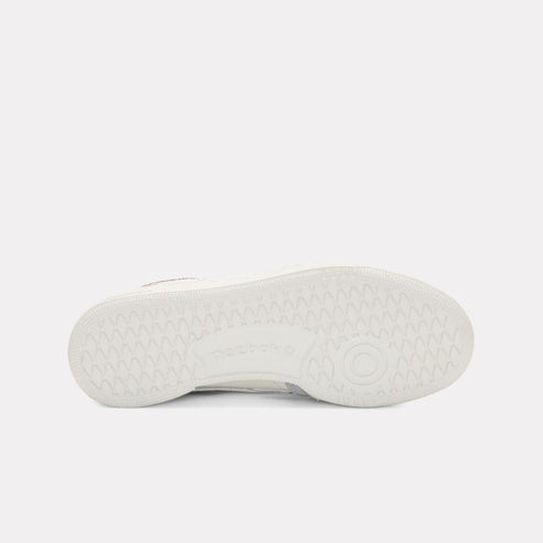 White sneaker sole with a geometric tread pattern.