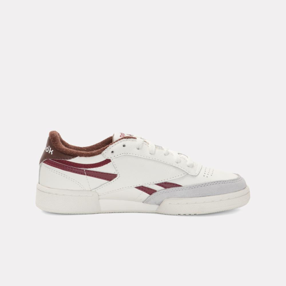 White low-top sneaker with maroon accents.