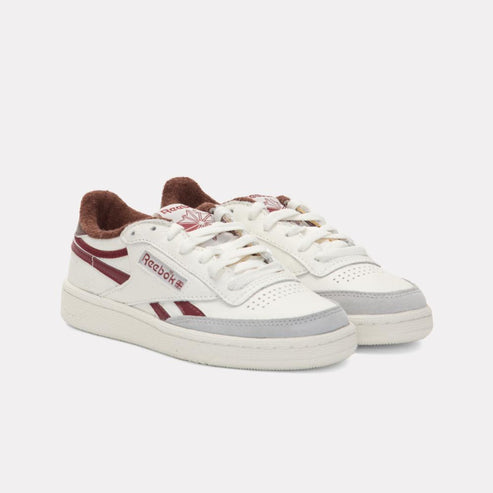 Low-top white sneakers with red stripes and fur lining.