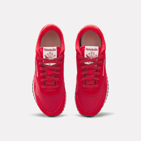 Pair of red sneakers with laces and visible "Reebok" logo.
