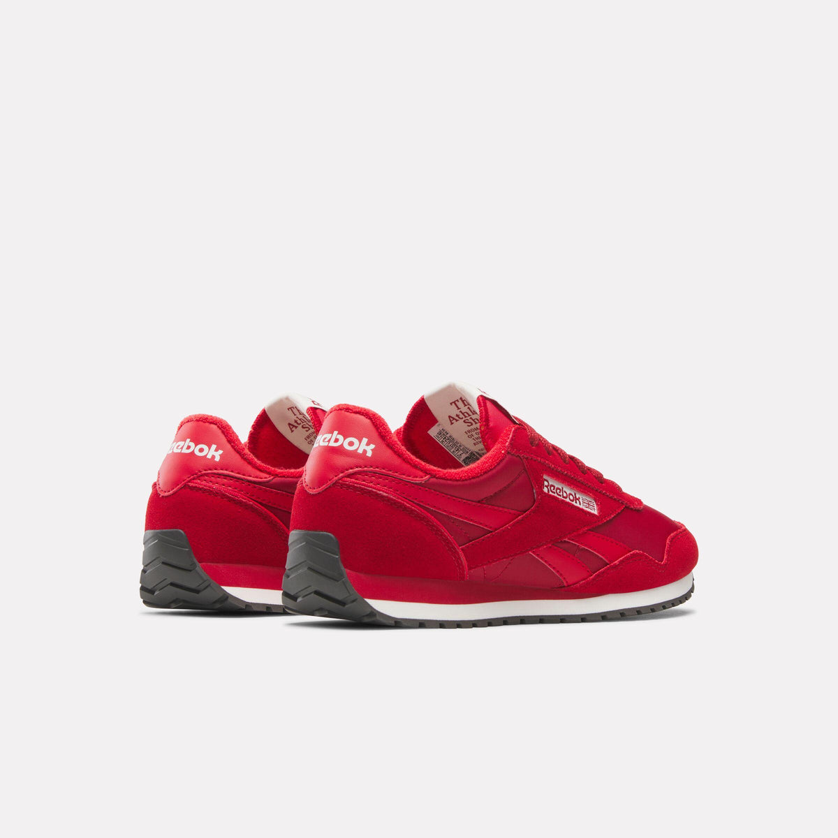Red sneakers with a white sole and black heel.