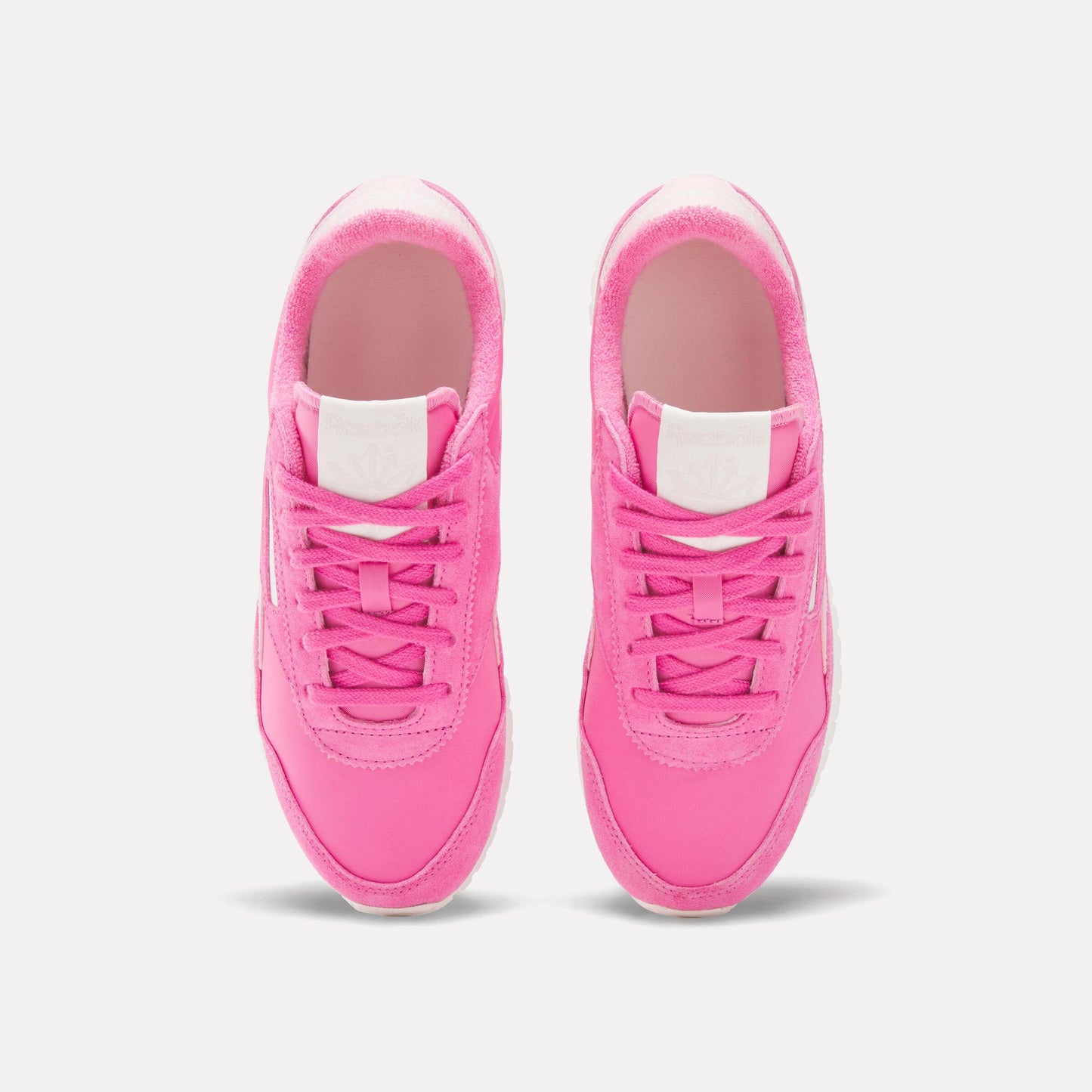 Pair of pink running shoes with white accents.