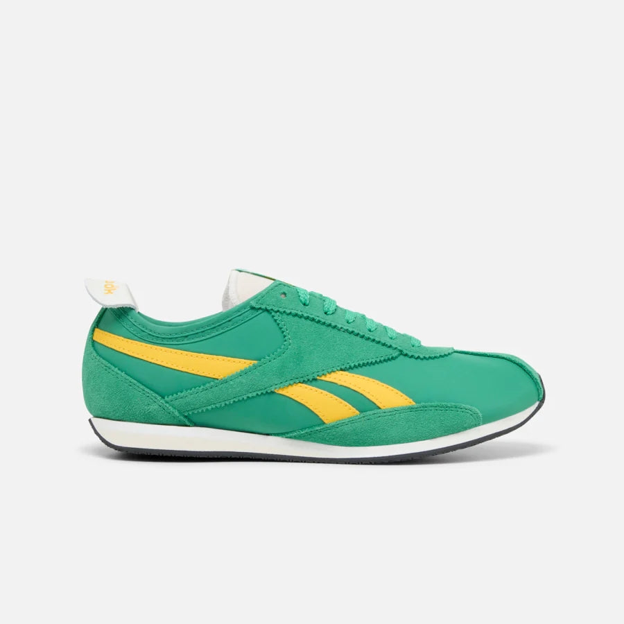 Green and yellow running shoe with white sole.