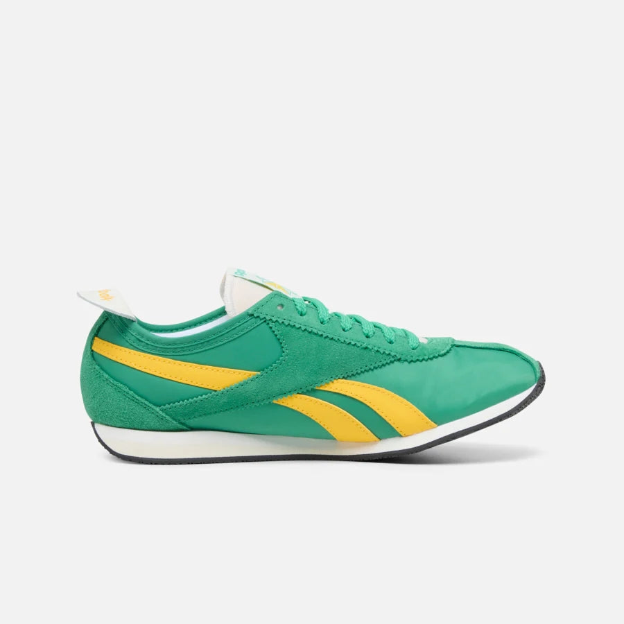 Green running shoe with yellow stripes.