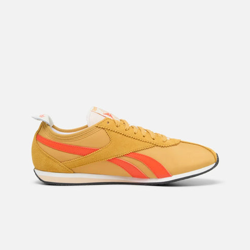 Low-profile yellow shoe with orange stripes.