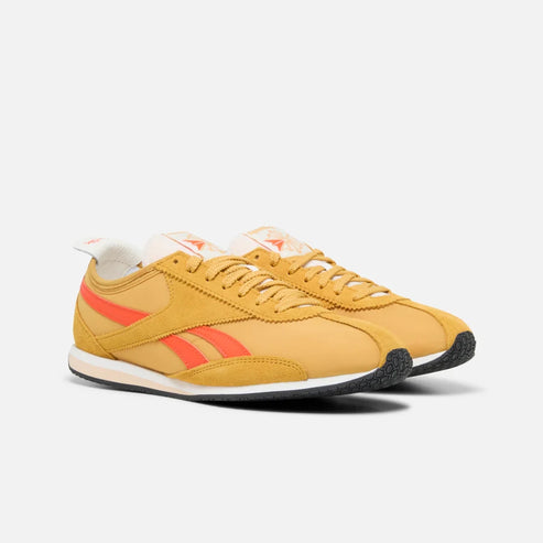 Gold sneaker with red stripe.