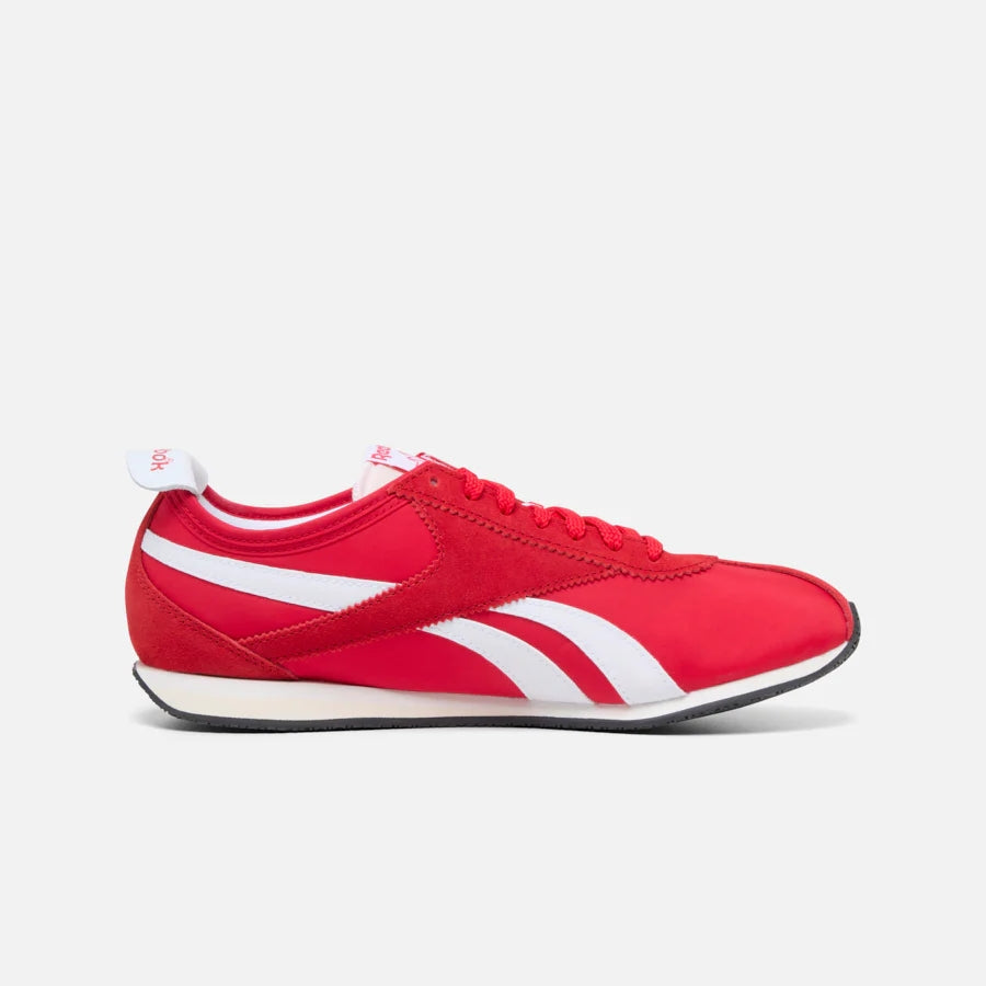 Red sneaker with white stripes and laces.