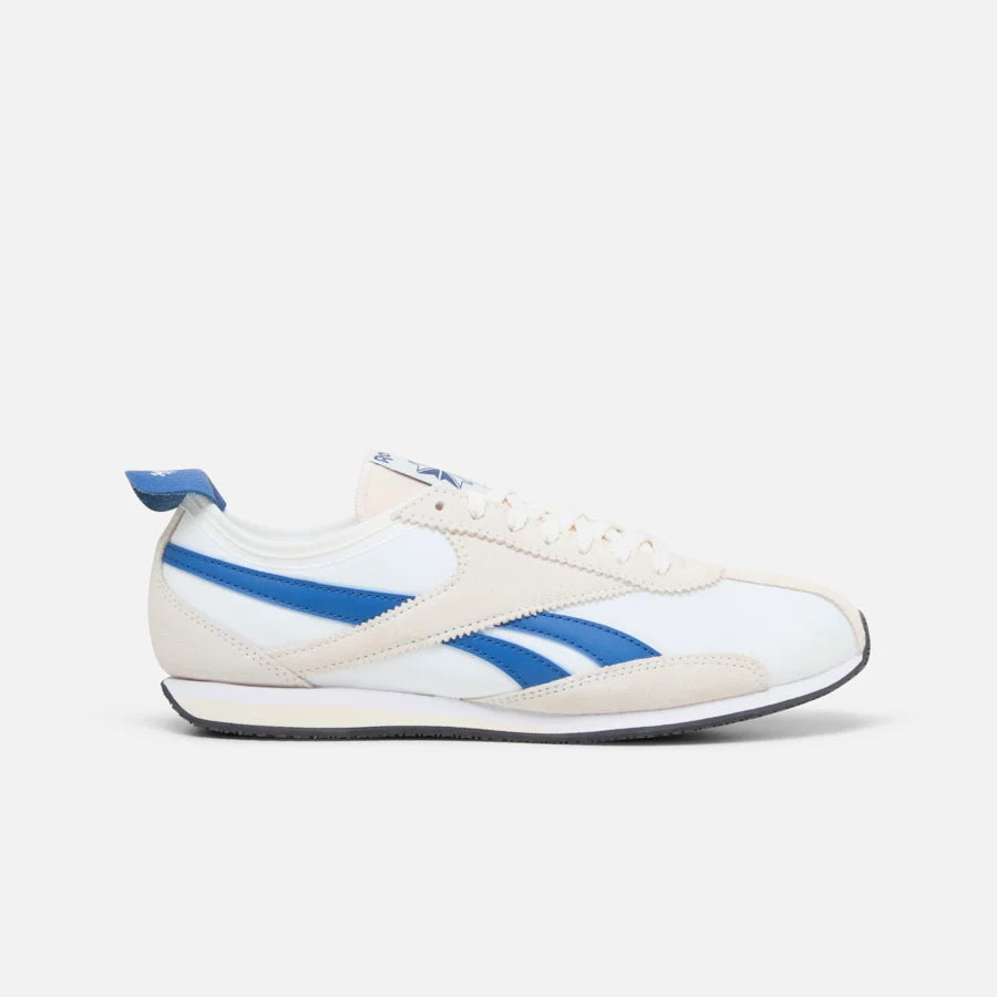 White sneaker with blue stripes and heel accent, off-white suede toe and side panel.