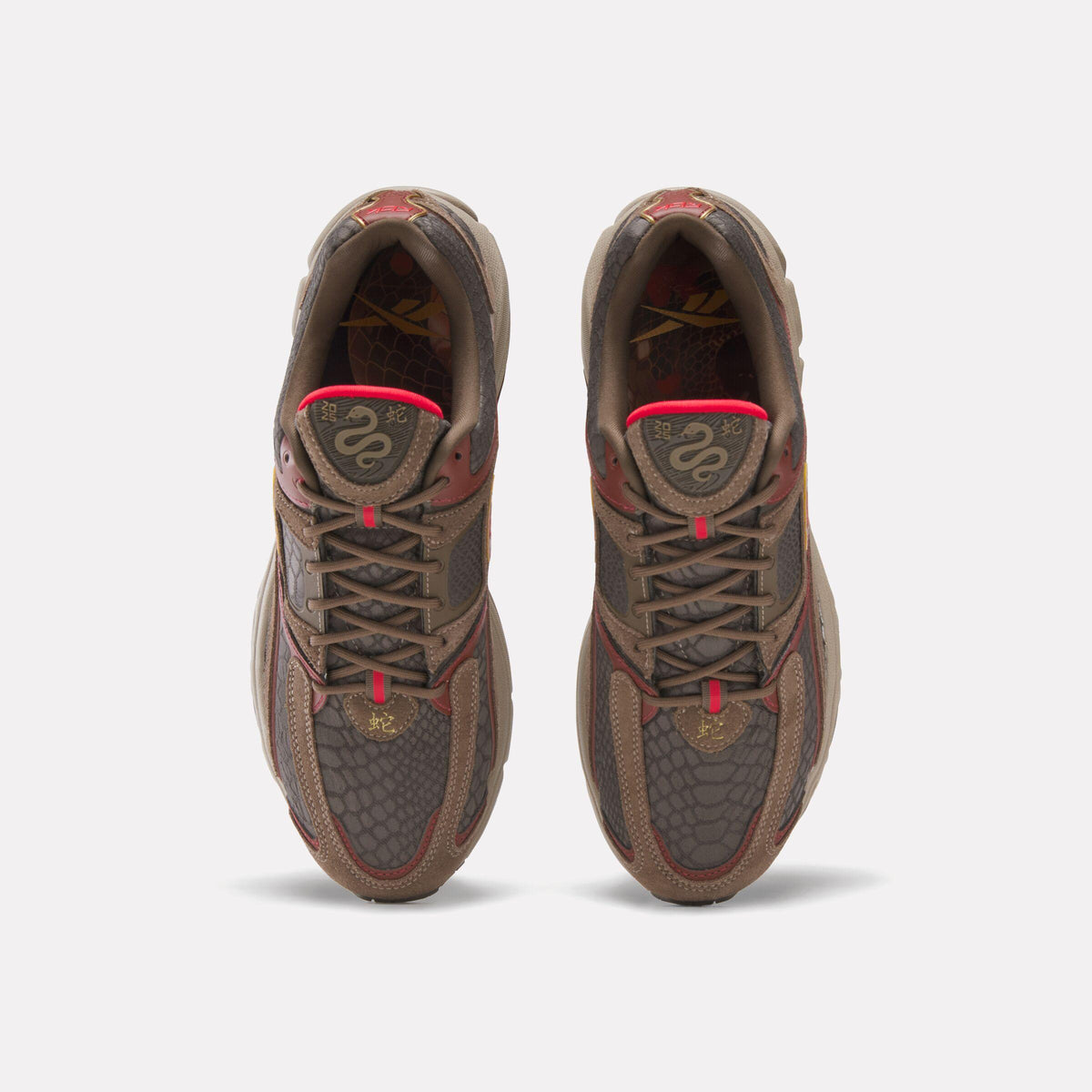 Overhead view of brown sneakers with snake design on tongue and toe.