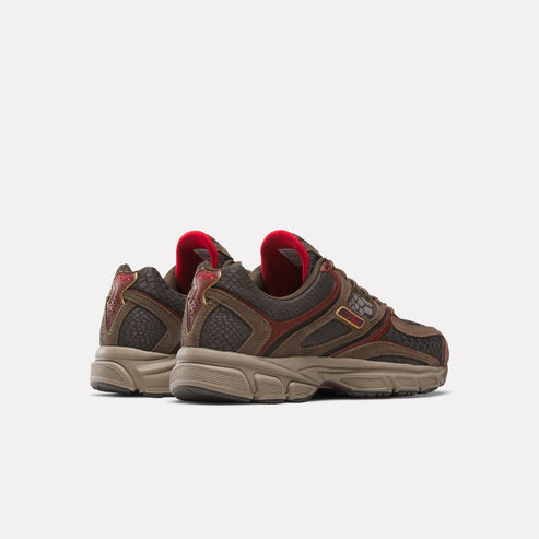 Rear angle of brown, red and beige running shoes with snake skin details.