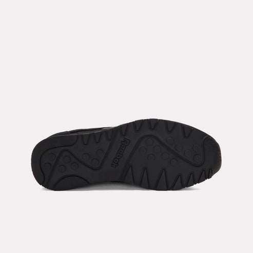 Black sneaker sole with brand name and triangular tread pattern.