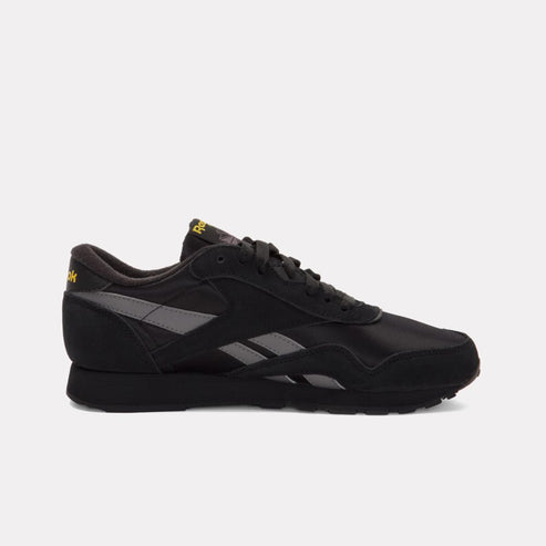 Black sneaker with gray details and gold accents.