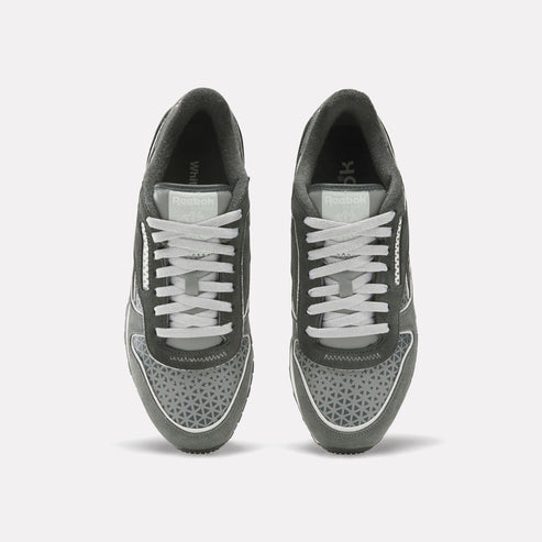 Pair of gray running shoes with white laces seen from above, showing tongue label.