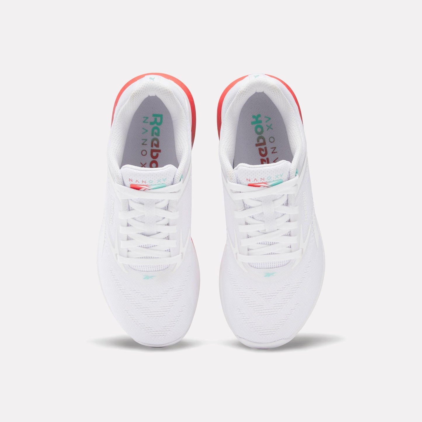 A pair of white sneakers with red accents and white laces.