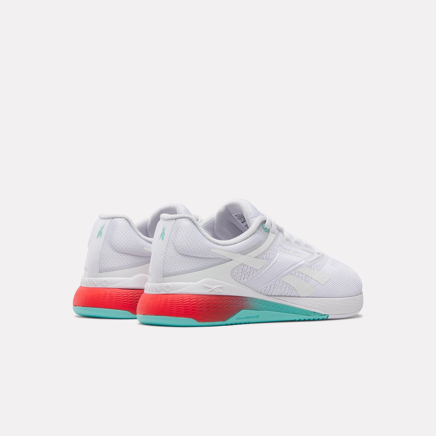Low top sneaker, white mesh upper, white laces, red and teal gradient heel.