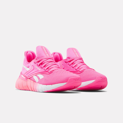 Pink athletic shoes with white accents and laces.
