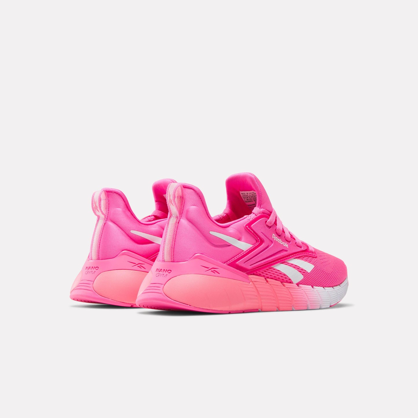 Pair of bright pink athletic shoes with white accents and gradient soles.