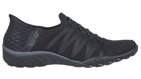 Black slip-on sneaker with elastic bands across the top and "SKECHERS SLIP-INS" text on the heel.