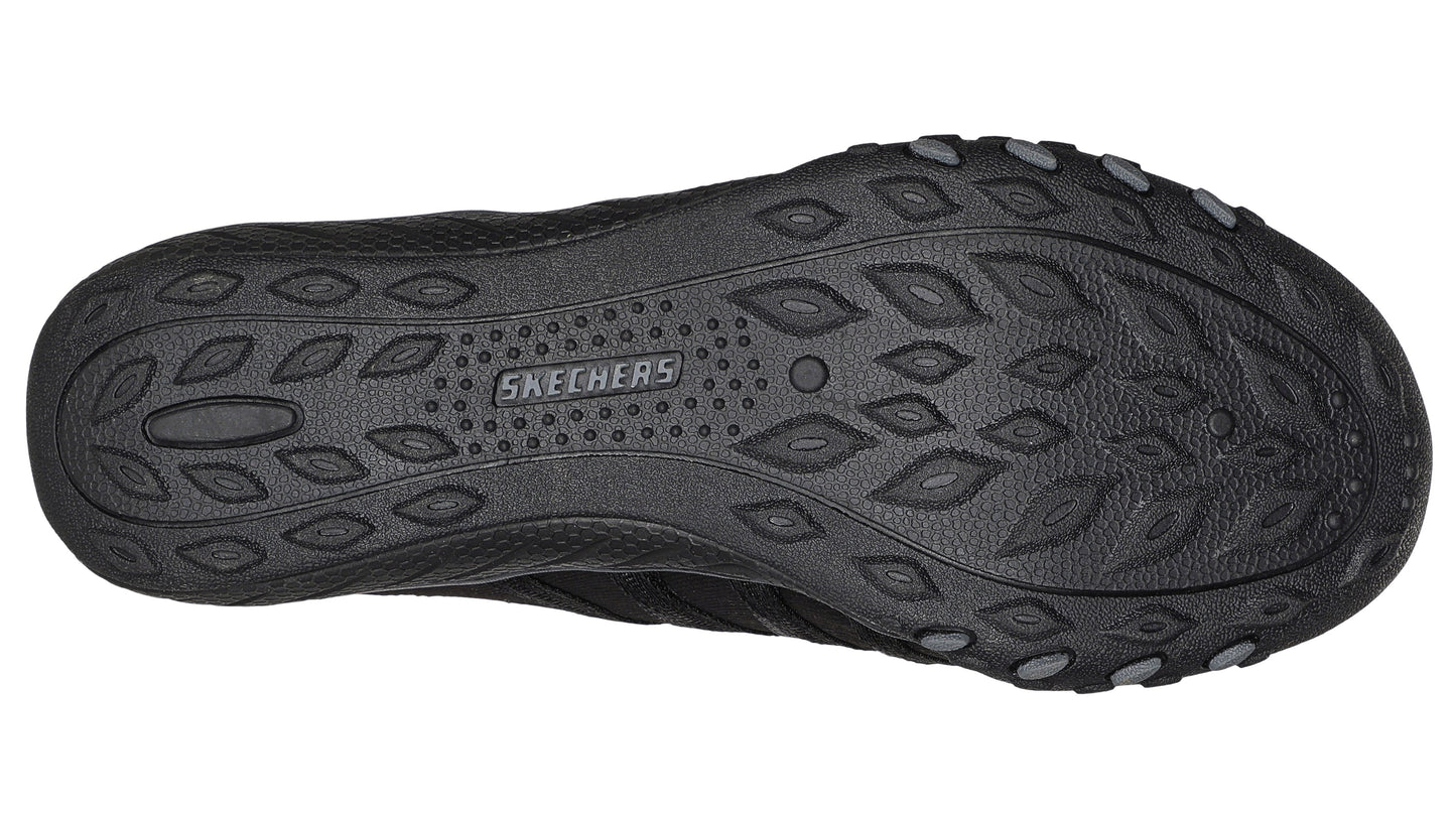 Black shoe outsole with textured oval pattern.