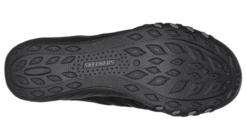Black shoe outsole with textured oval pattern.