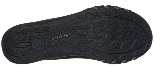 A black shoe sole with the word SKECHERS printed on it.