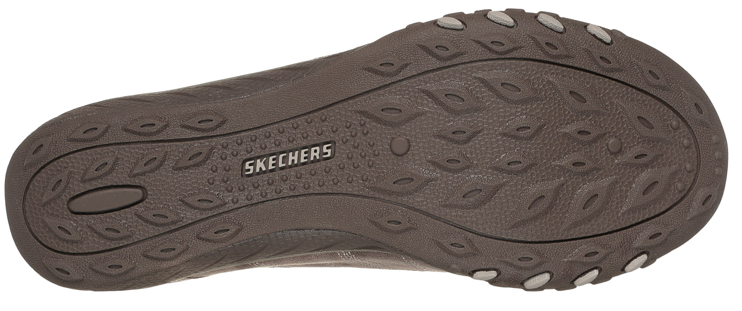 The outsole of a shoe is brown and features the brand name "SKECHERS" in the center, surrounded by an oval tread pattern.
