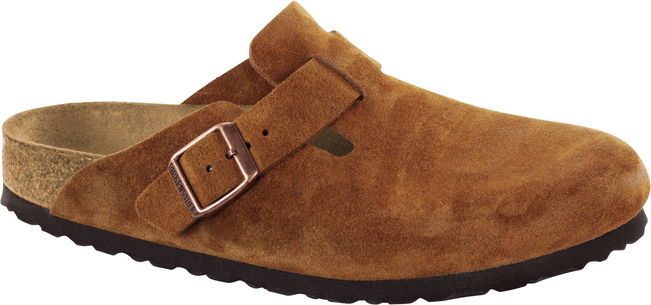 A brown clog-style shoe made of suede with an adjustable strap and buckle.